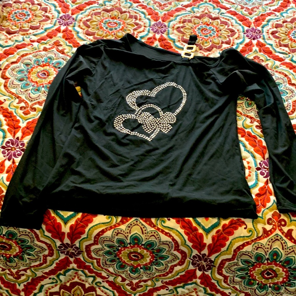 Black long sleeve polyester shirt with stud hearts in the middle.